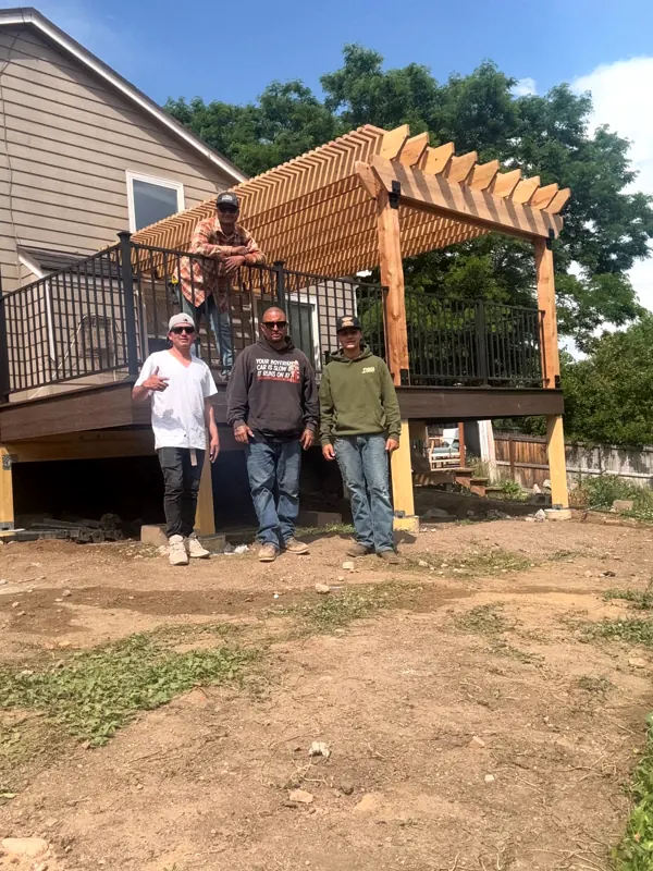Longs Peak Framing crew in front of a completed raised deck and pergola